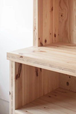 A zoom photograph of a pine timber shelving unit.