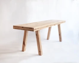 A bespoke pine timber bench photographed at an angle on a white background.