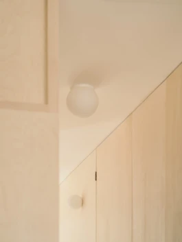 A photograph of a white ceiling with small round lights.