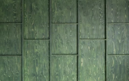 A zoom photograph of timber wall panelling with a dark green wood stain.