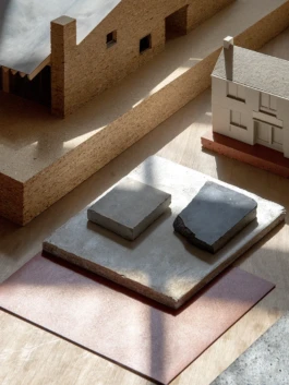 Architectural models and material samples on a table
