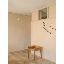 A house interior with parquet flooring and birch plywood timber panelling on the walls. 